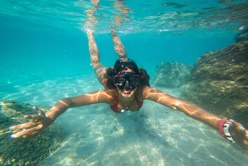 Snorkeler floating over a tropical reef in Waikiki